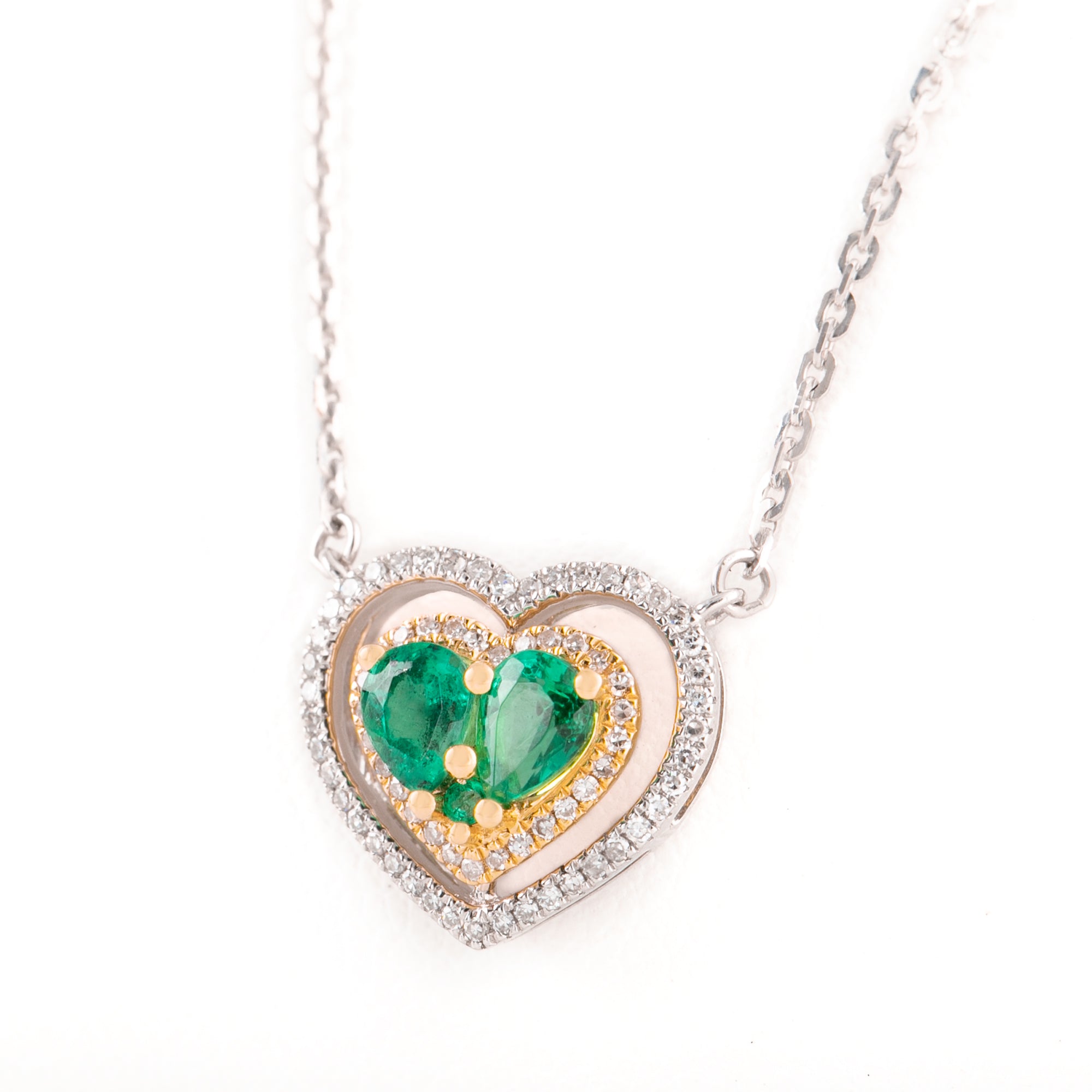 Gargantilla de corazones en  2 oros con diamantes y esmeralda